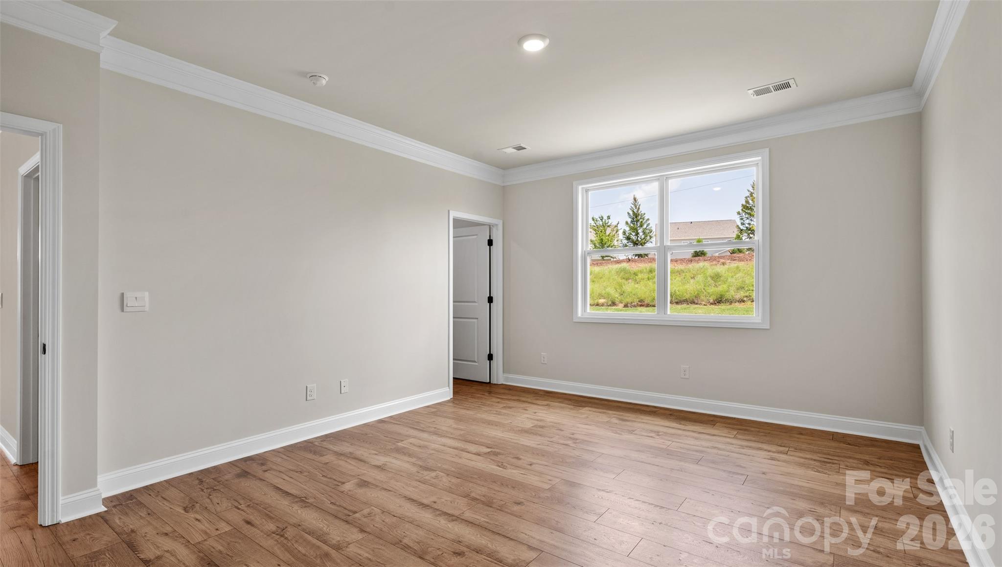 662 River Btm Road Fletcher, NC 28732 - Photo 20 of 31 an empty room with wooden floor and windows