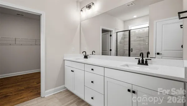 a bathroom with double vanity sink and a mirror
