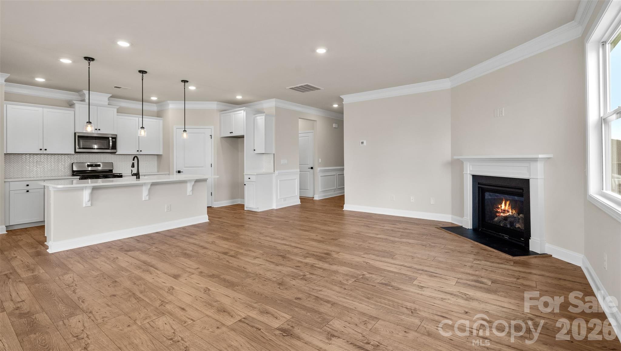 662 River Btm Road Fletcher, NC 28732 - Photo 9 of 31 a view of kitchen with kitchen island a sink wooden floor and a fireplace