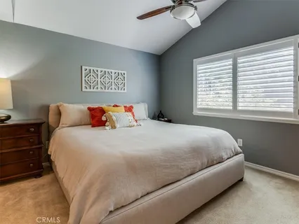 a bedroom with a large bed and a couch