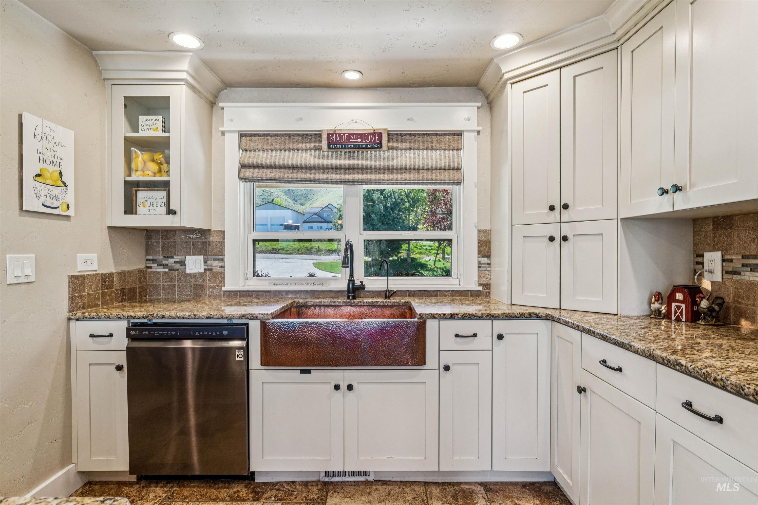 1050 West South Slope Road Emmett, ID 83617 - Photo 12 of 49 Kitchen featuring backsplash, dishwasher, dark stone countertops, and recessed lighting