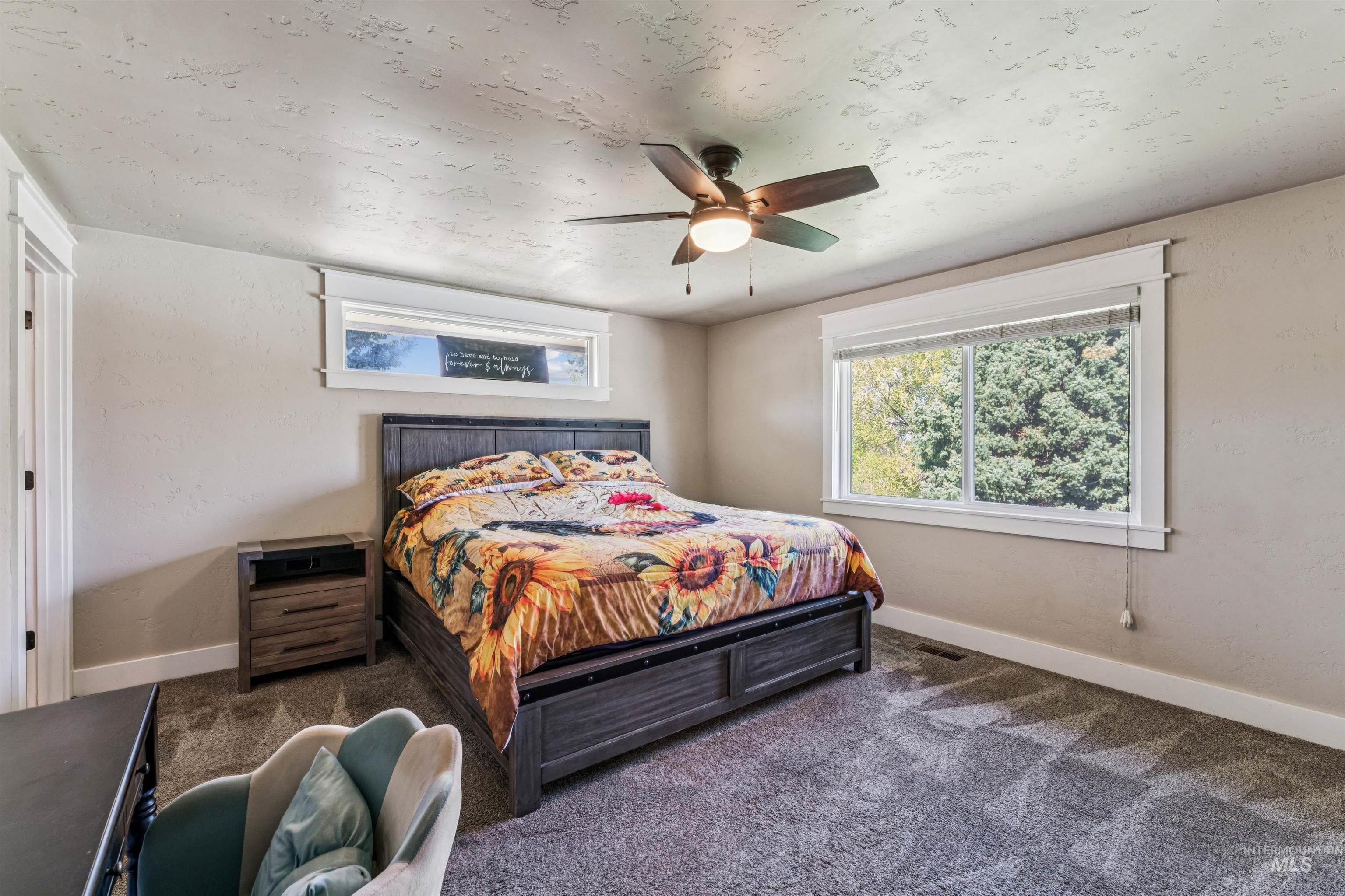 1050 West South Slope Road Emmett, ID 83617 - Photo 16 of 49 Bedroom featuring a ceiling fan and dark colored carpet