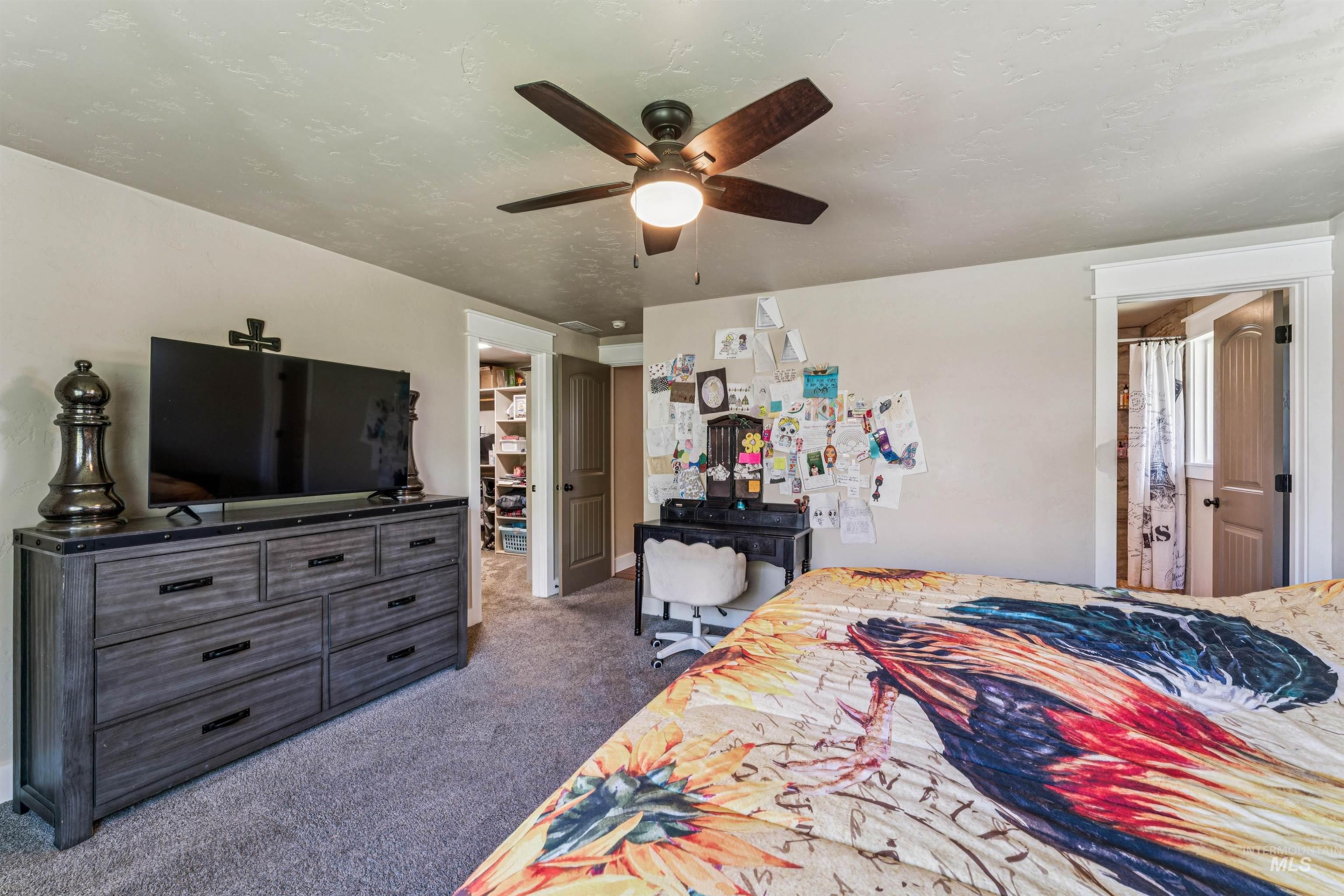 1050 West South Slope Road Emmett, ID 83617 - Photo 19 of 49 Bedroom featuring dark carpet, ceiling fan, and a textured ceiling