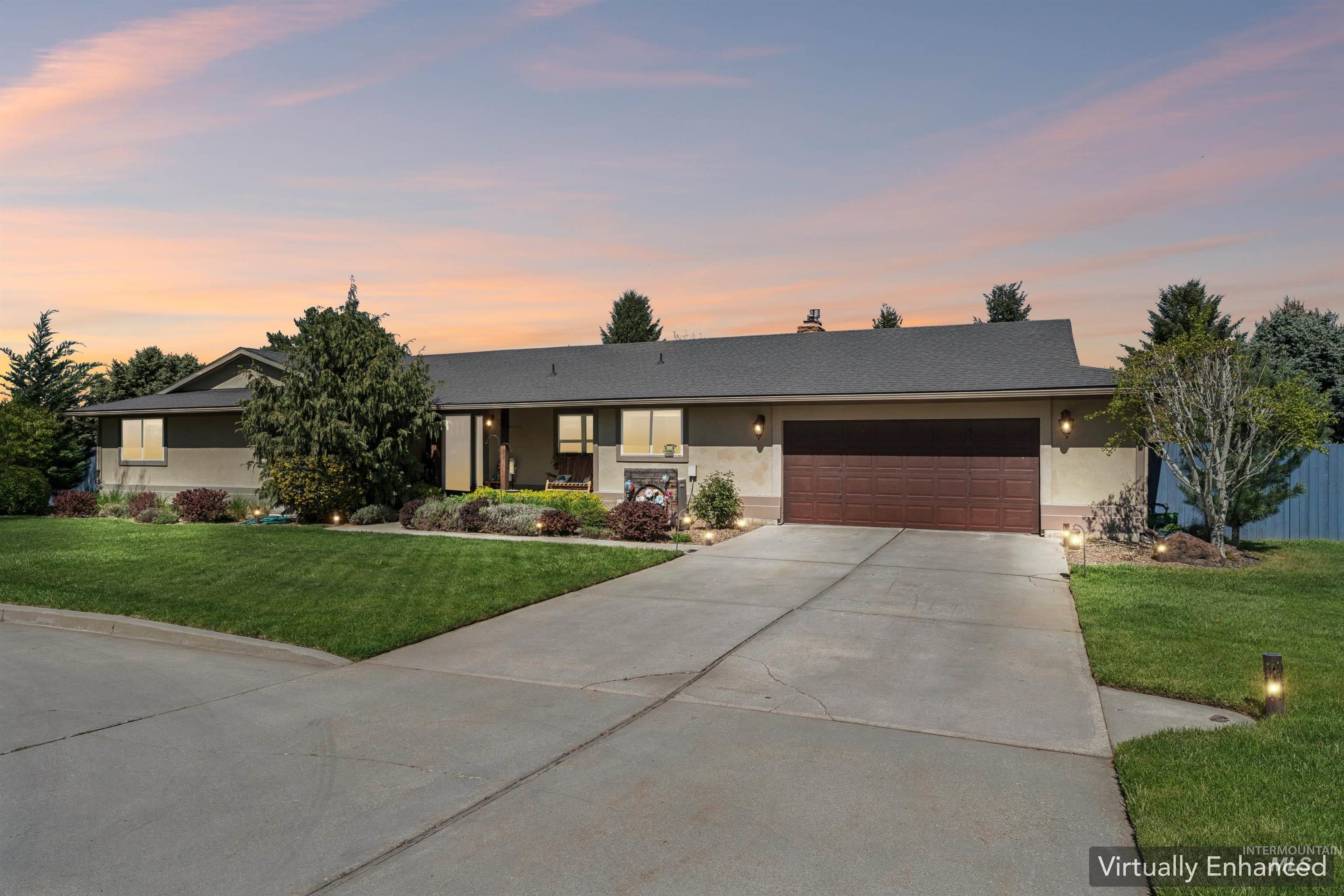 1050 West South Slope Road Emmett, ID 83617 - Photo 2 of 49 Ranch-style home featuring driveway, a lawn, an attached garage, and stucco siding