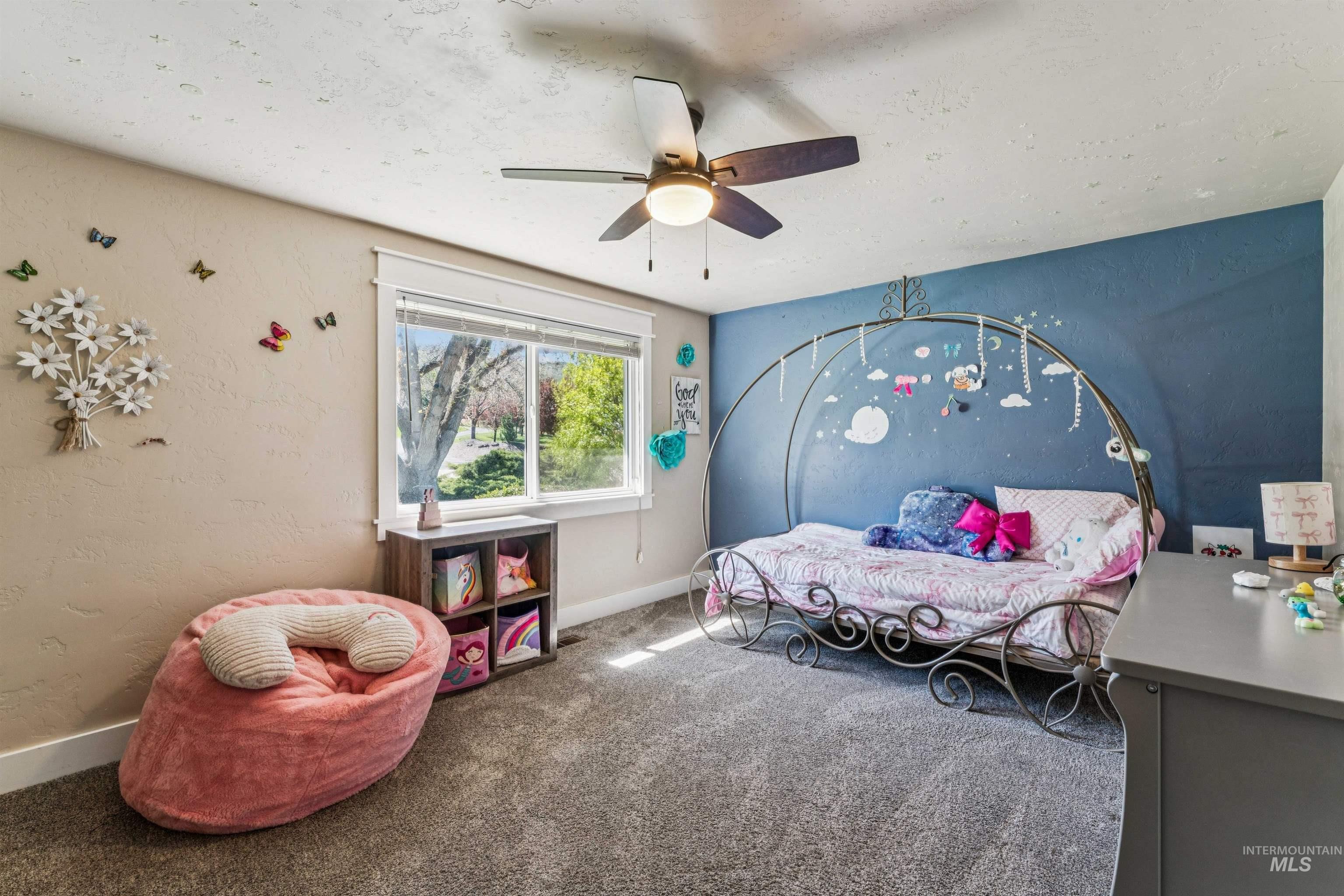 1050 West South Slope Road Emmett, ID 83617 - Photo 22 of 49 Carpeted bedroom featuring a ceiling fan and a textured wall