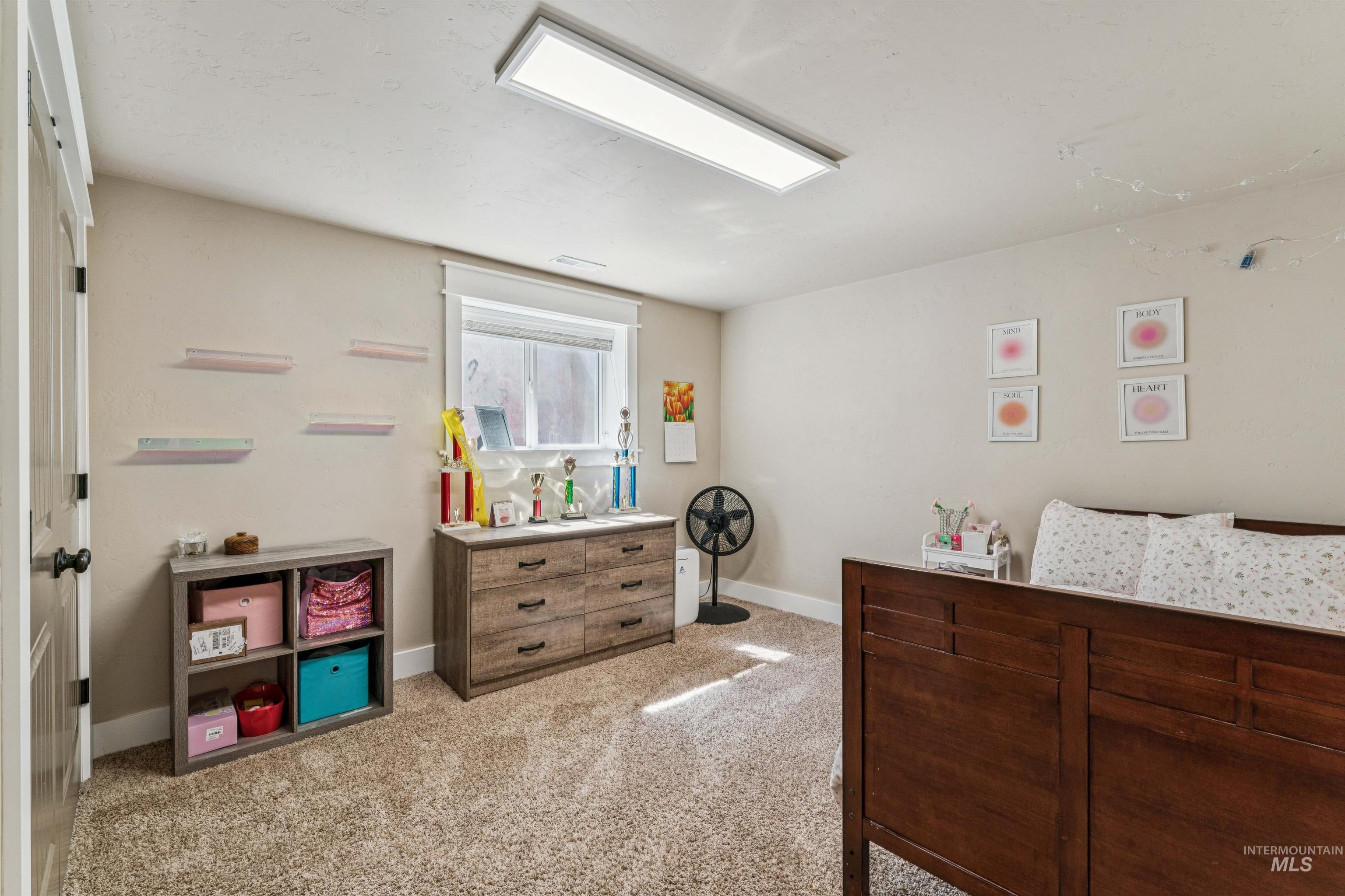 1050 West South Slope Road Emmett, ID 83617 - Photo 24 of 49 Bedroom with light carpet and baseboards