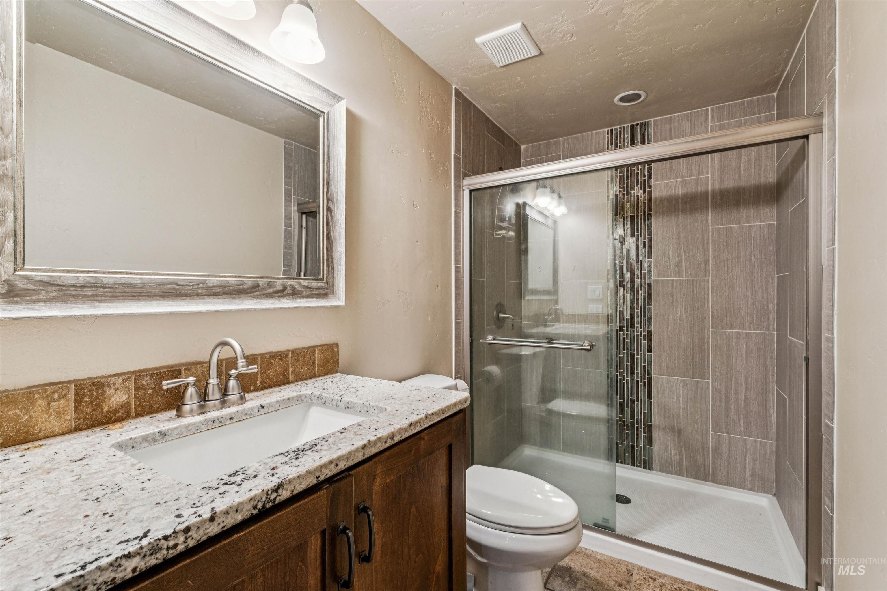 1050 West South Slope Road Emmett, ID 83617 - Photo 26 of 49 Bathroom featuring vanity and a shower stall