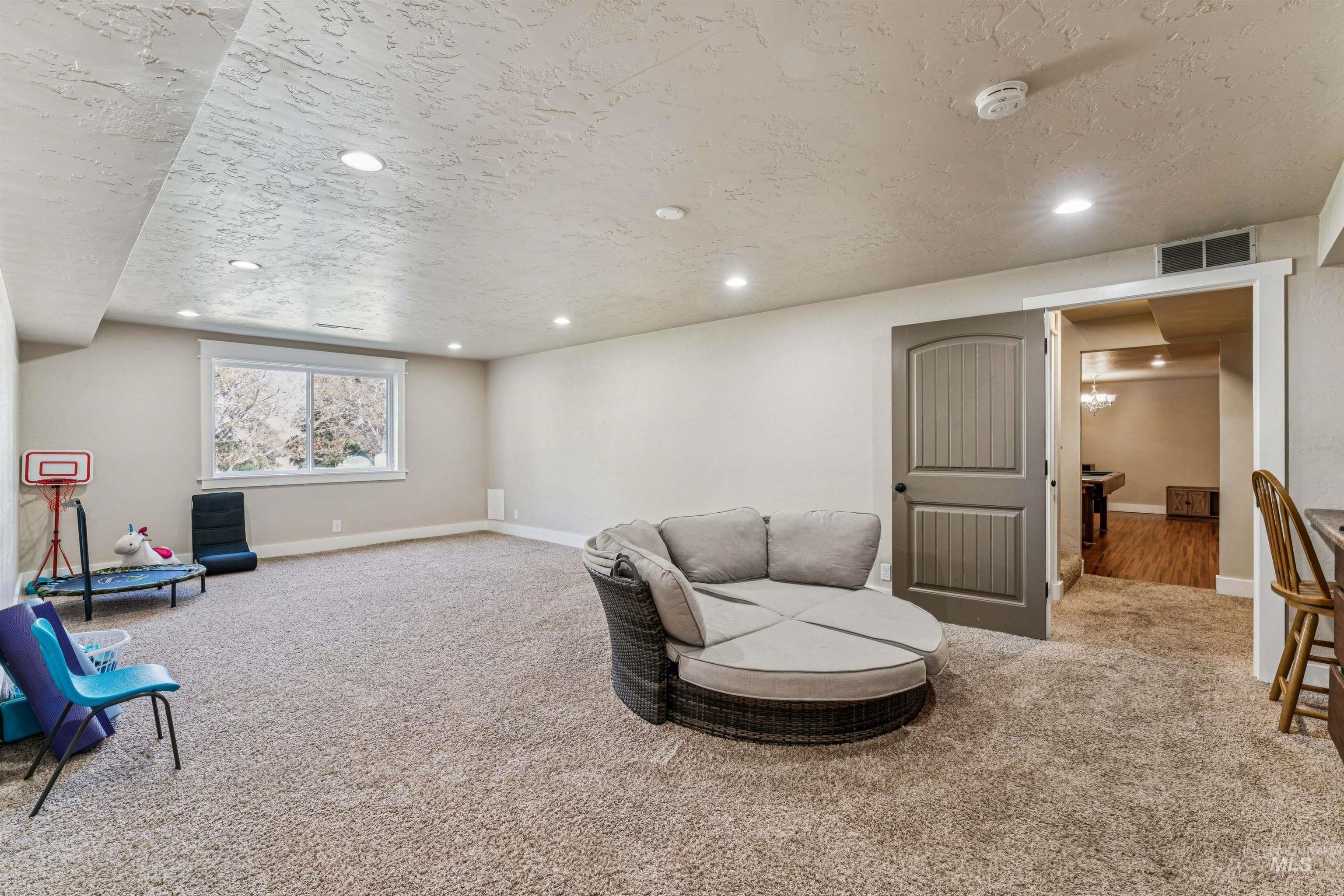 1050 West South Slope Road Emmett, ID 83617 - Photo 31 of 49 Sitting room with recessed lighting, light carpet, and a textured ceiling