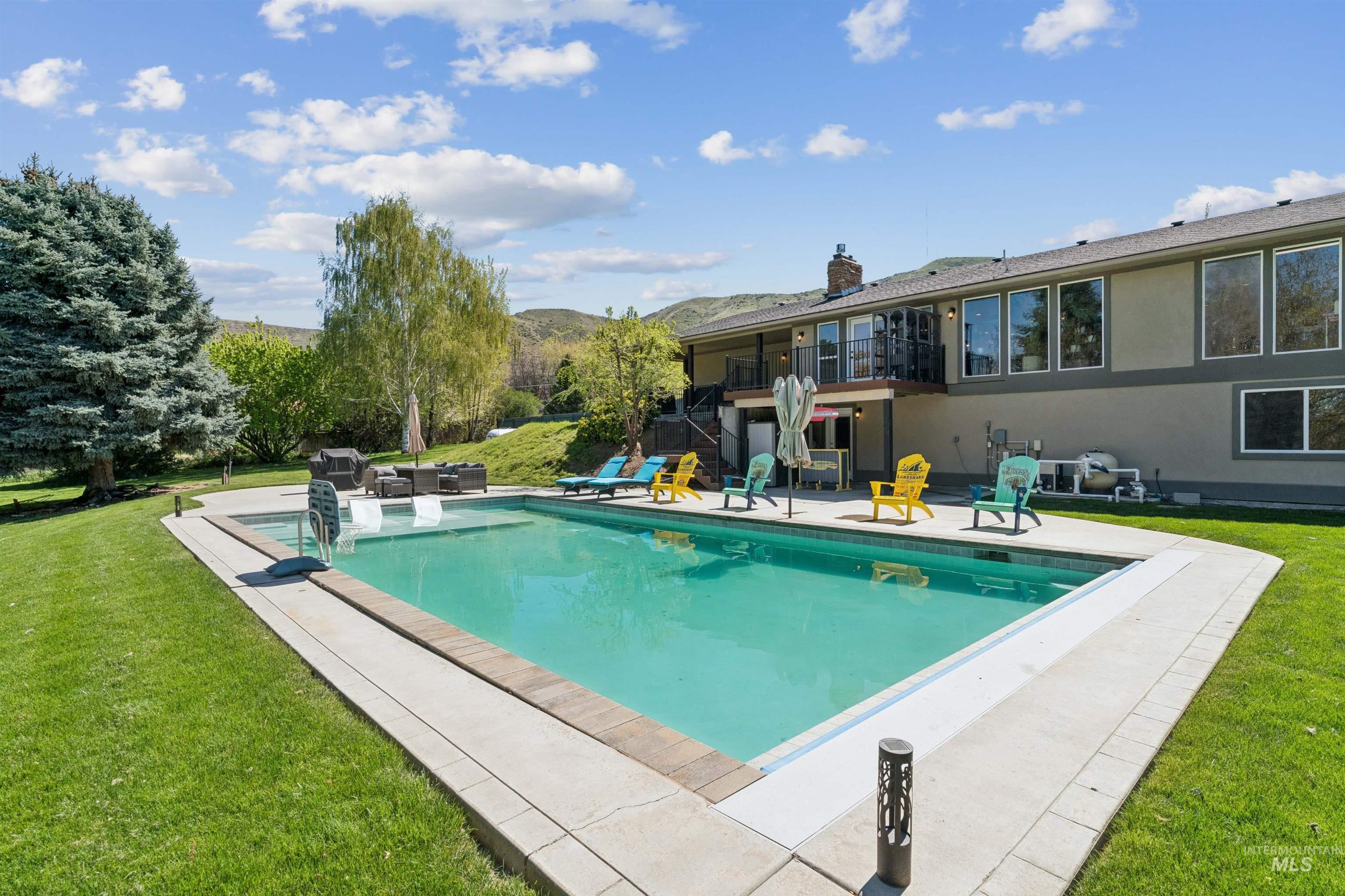 1050 West South Slope Road Emmett, ID 83617 - Photo 33 of 49 Outdoor pool with a yard, a patio area, and a mountain view