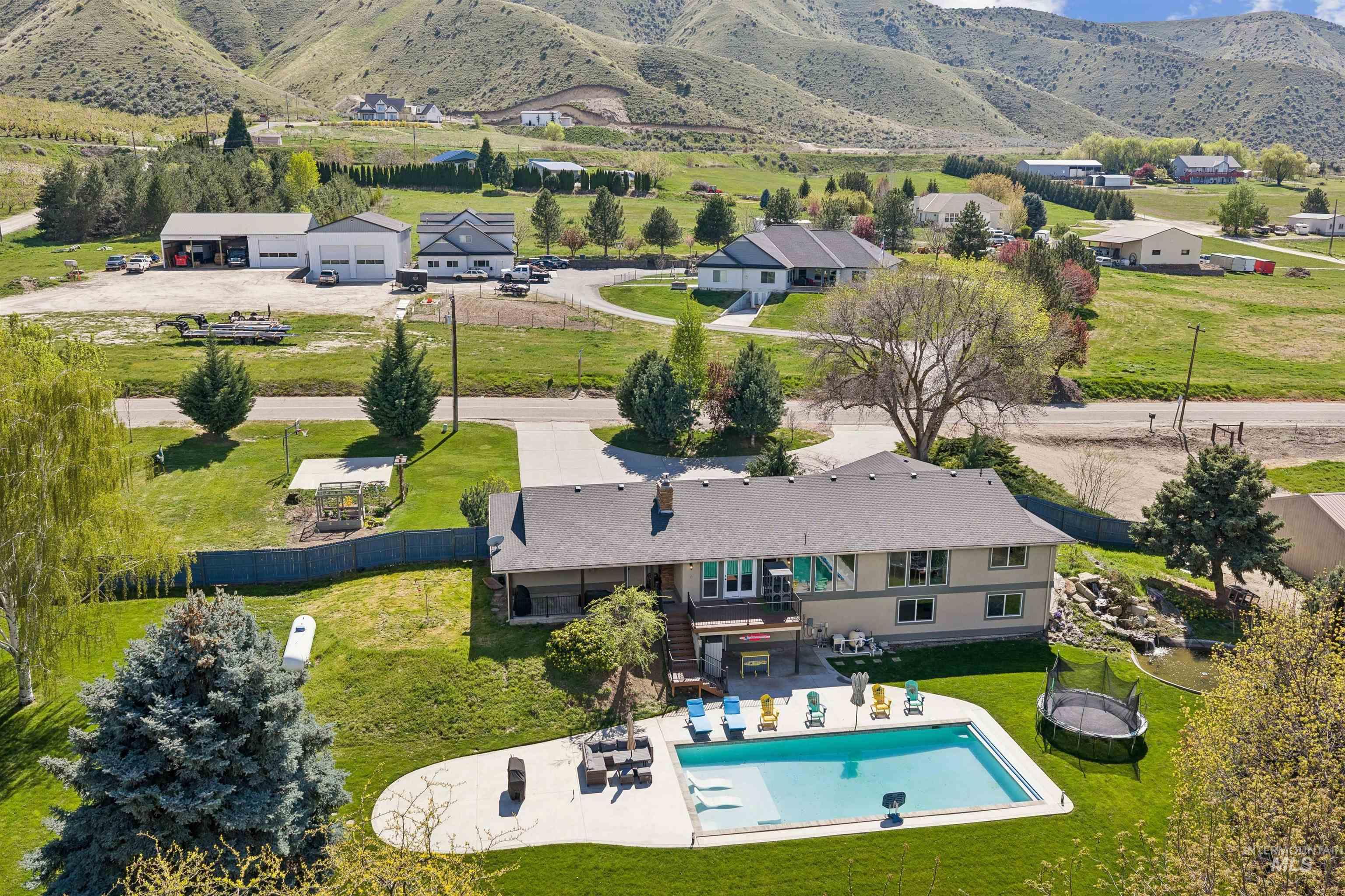 1050 West South Slope Road Emmett, ID 83617 - Photo 45 of 49 View of subject property featuring a mountain backdrop and a pool area