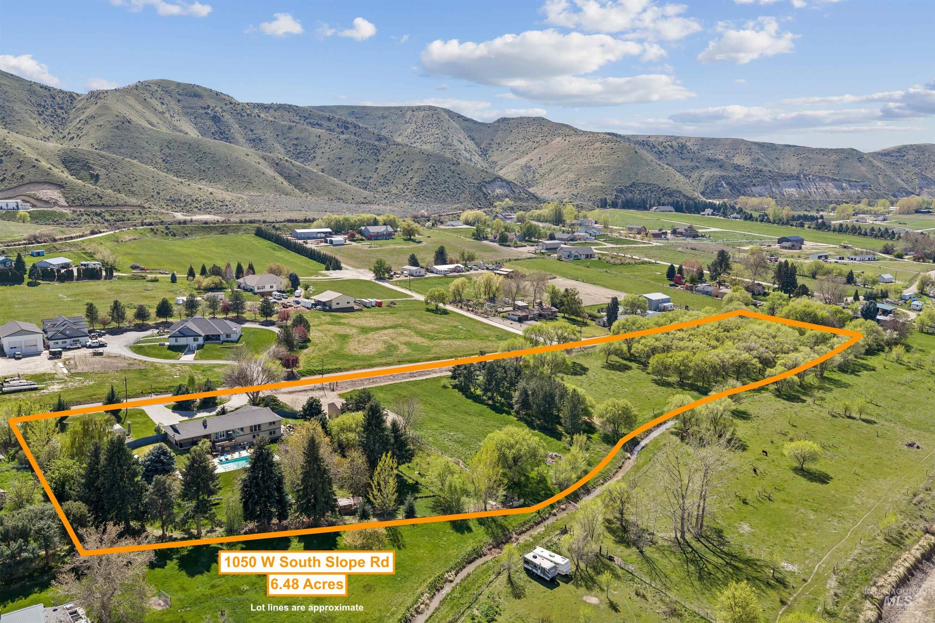 1050 West South Slope Road Emmett, ID 83617 - Photo 47 of 49 Aerial view of property and surrounding area featuring property boundaries highlighted and a mountainous background