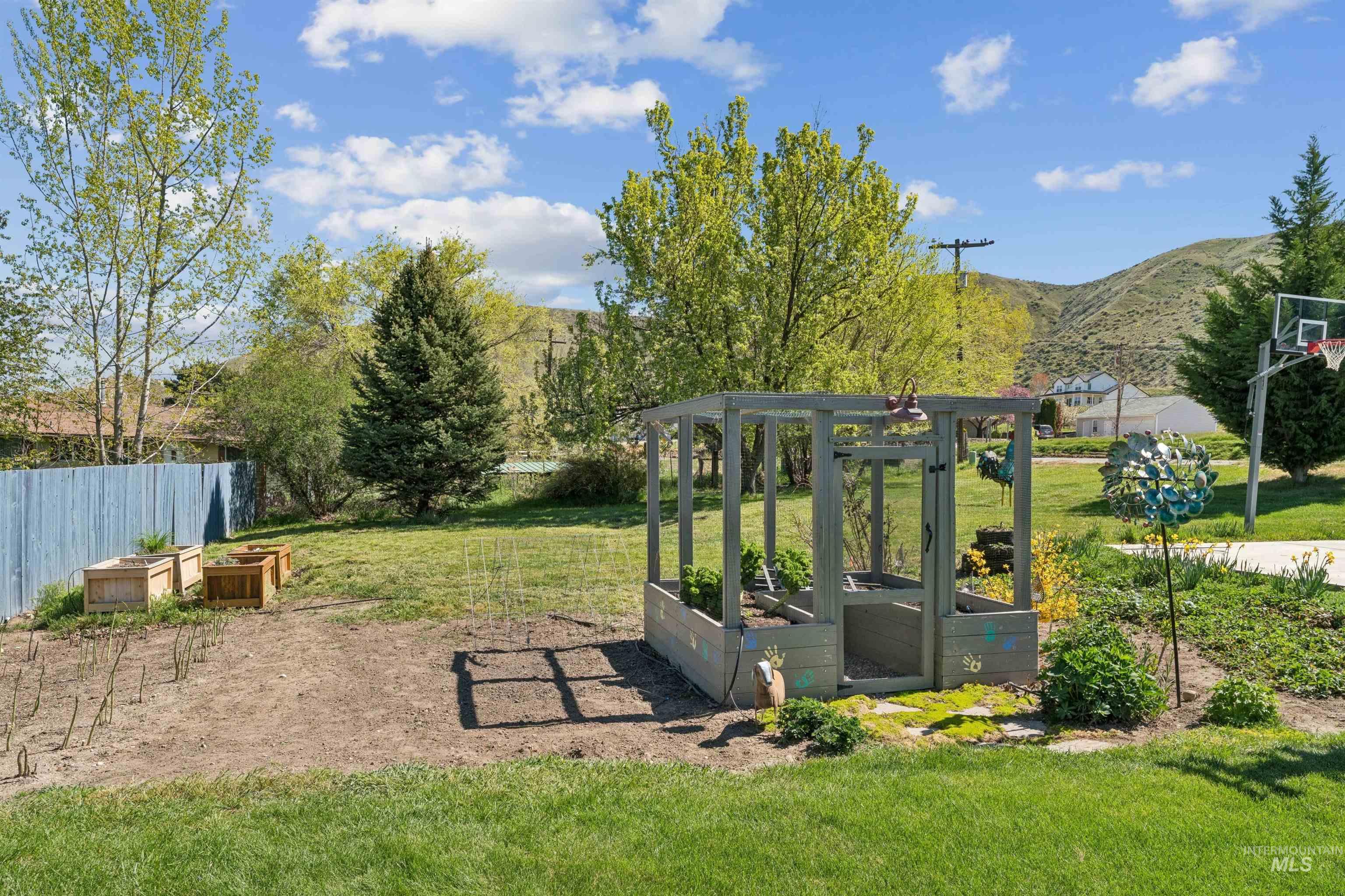 1050 West South Slope Road Emmett, ID 83617 - Photo 48 of 49 View of yard featuring a garden and a mountain view