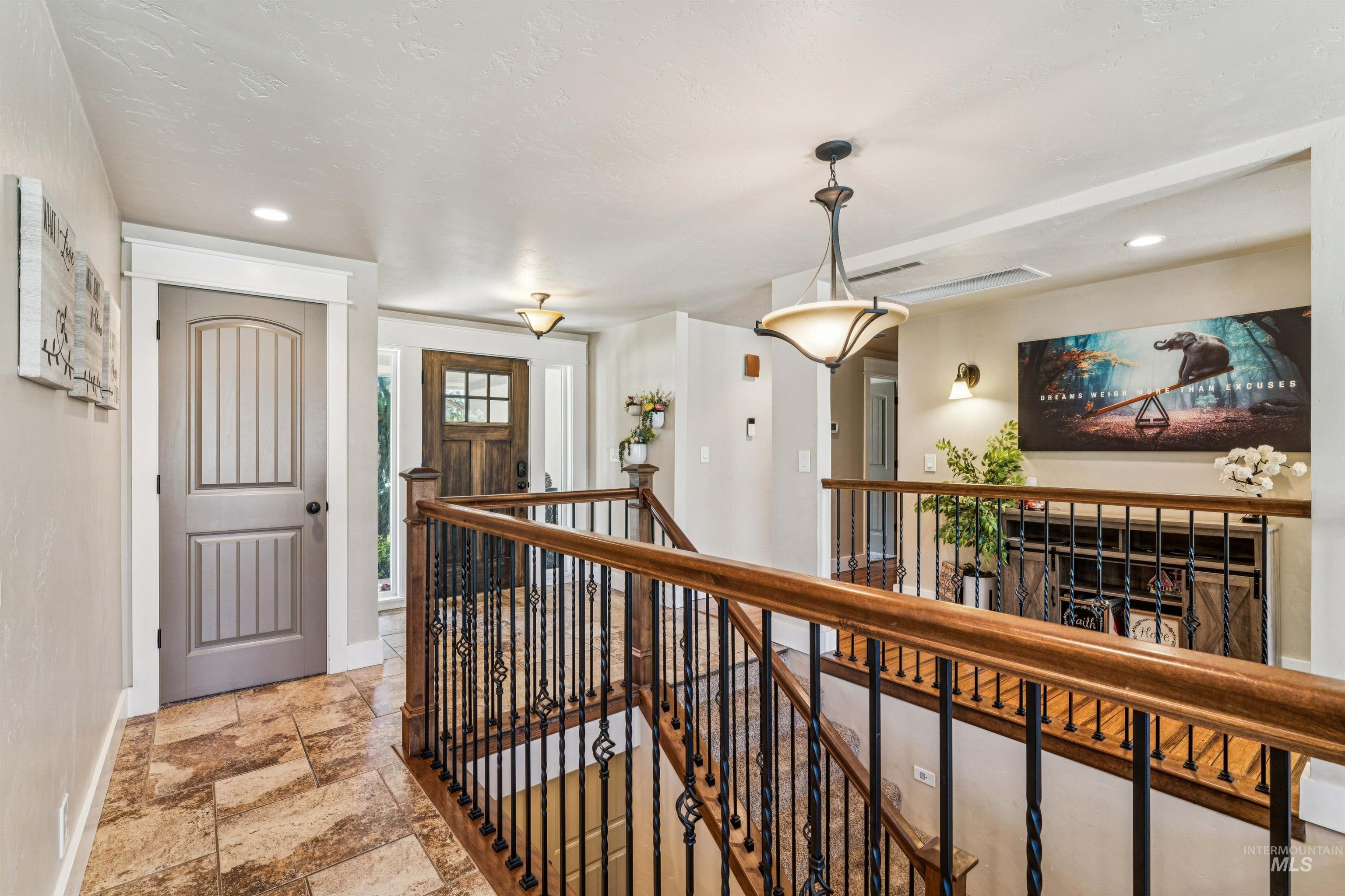 1050 West South Slope Road Emmett, ID 83617 - Photo 5 of 49 Hall featuring an upstairs landing, recessed lighting, and stone tile flooring
