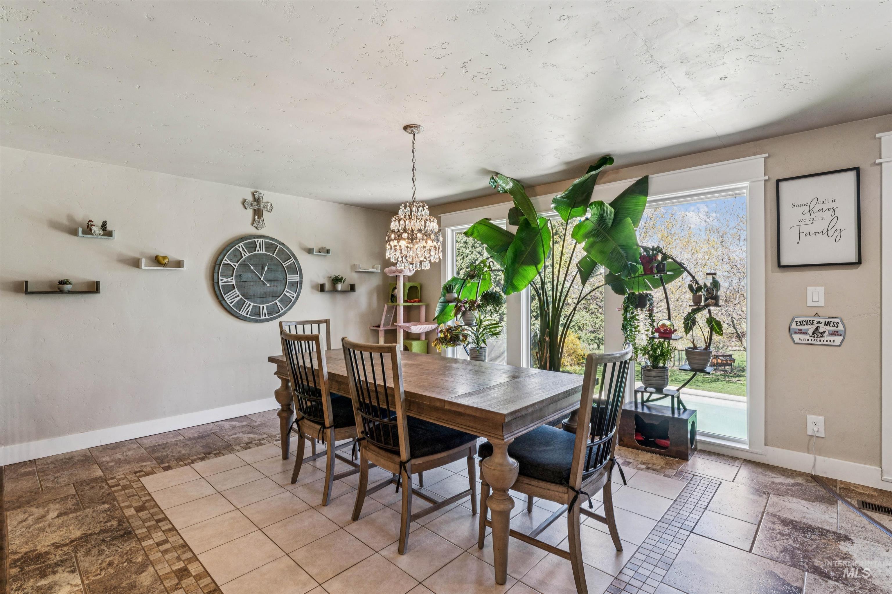 1050 West South Slope Road Emmett, ID 83617 - Photo 9 of 49 Dining area featuring hanging lights and stone tile floors