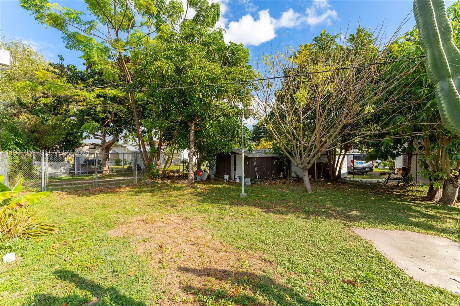 445 Northwest 8th Street Homestead, FL 33030 - Photo 20 of 32 a view of swimming pool with outdoor seating and trees in the background