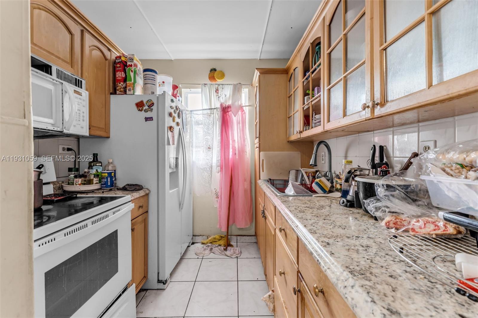 445 Northwest 8th Street Homestead, FL 33030 - Photo 5 of 32 a kitchen with stainless steel appliances granite countertop a stove and a sink