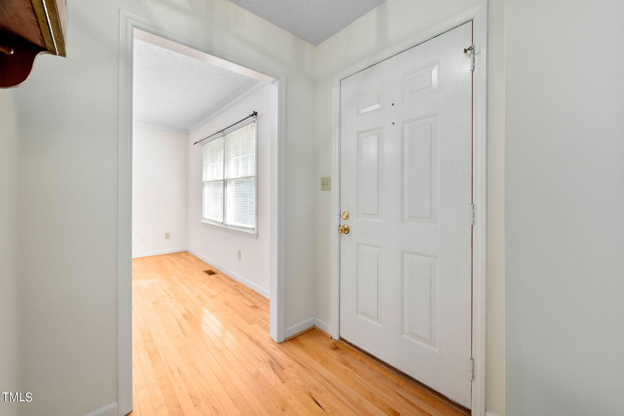 145 Fox Run Road Pinehurst, NC 28374 - Photo 4 of 32 a view of an empty room with wooden floor and a window
