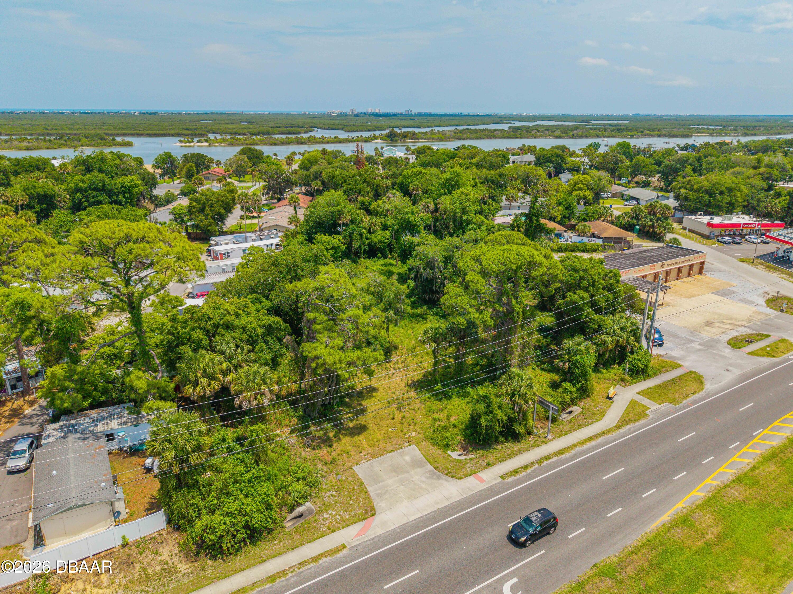 1711 South Ridgewood Avenue Edgewater, FL 32132 - Photo 2 of 10 an aerial view of residential houses with outdoor space and trees