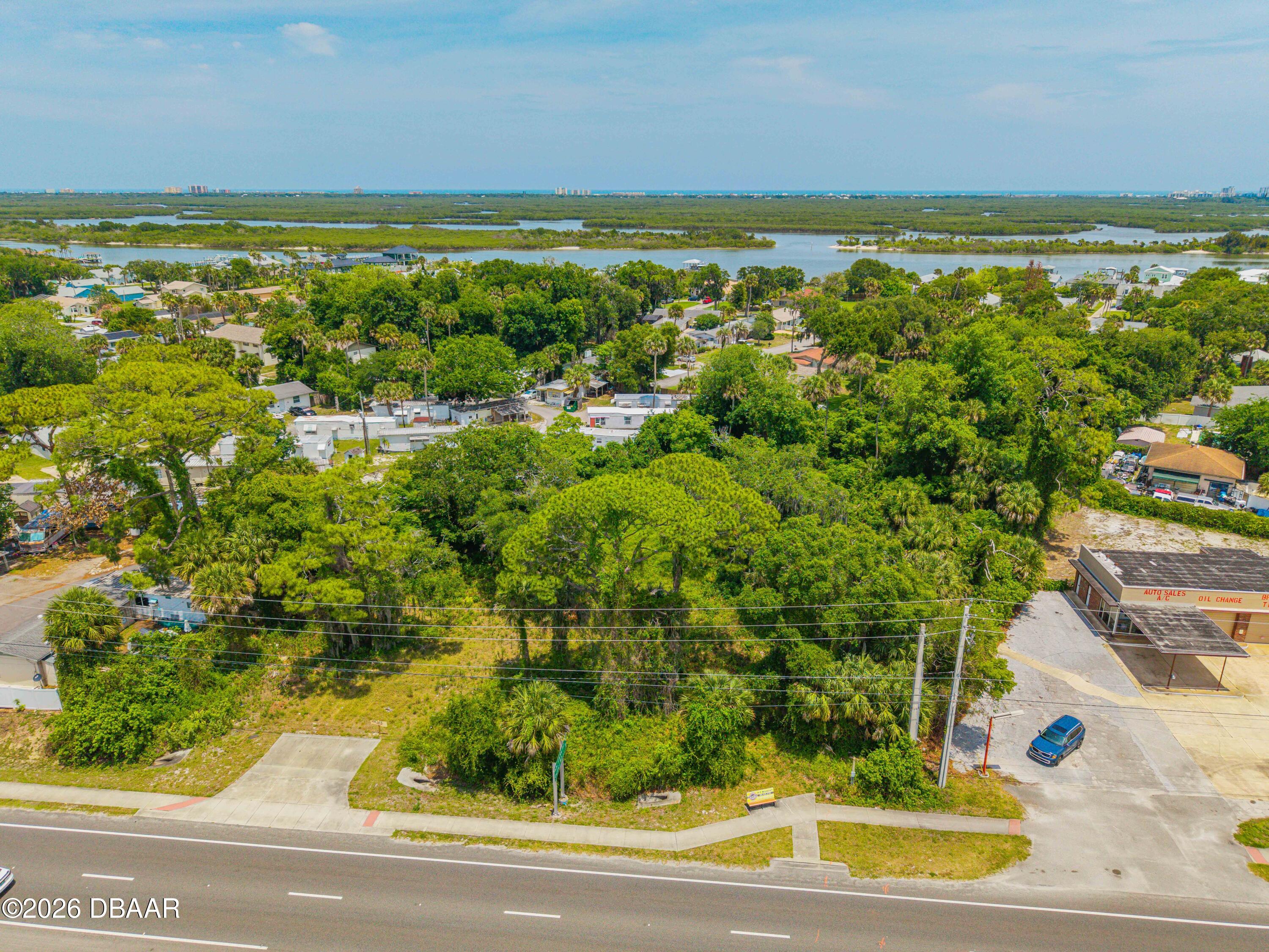 1711 South Ridgewood Avenue Edgewater, FL 32132 - Photo 3 of 10 a view of an ocean and a yard