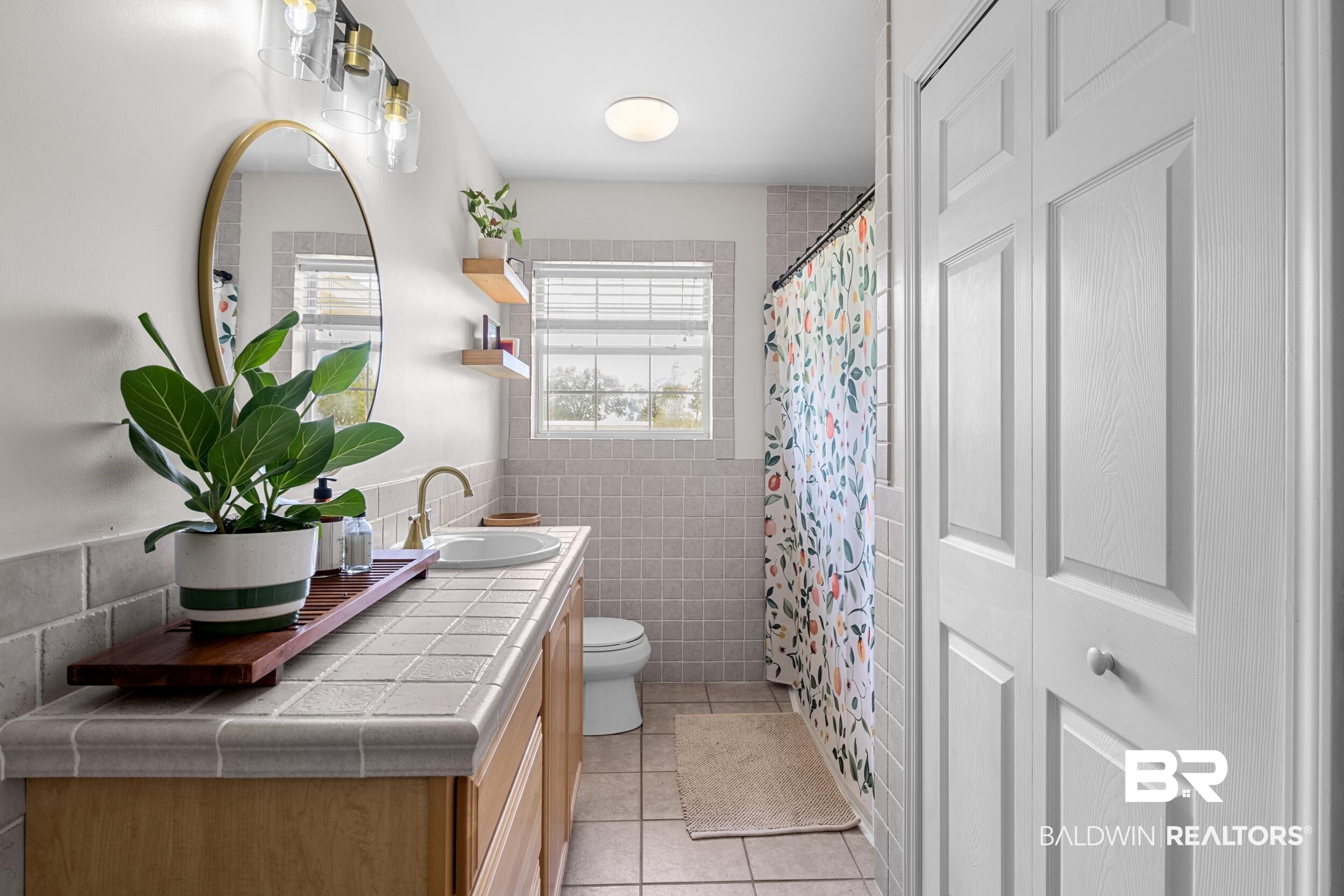 17689 Brewer Road Foley, AL 36535 - Photo 33 of 54 Bathroom featuring tile walls, walk in shower, tile patterned floors, vanity, and toilet