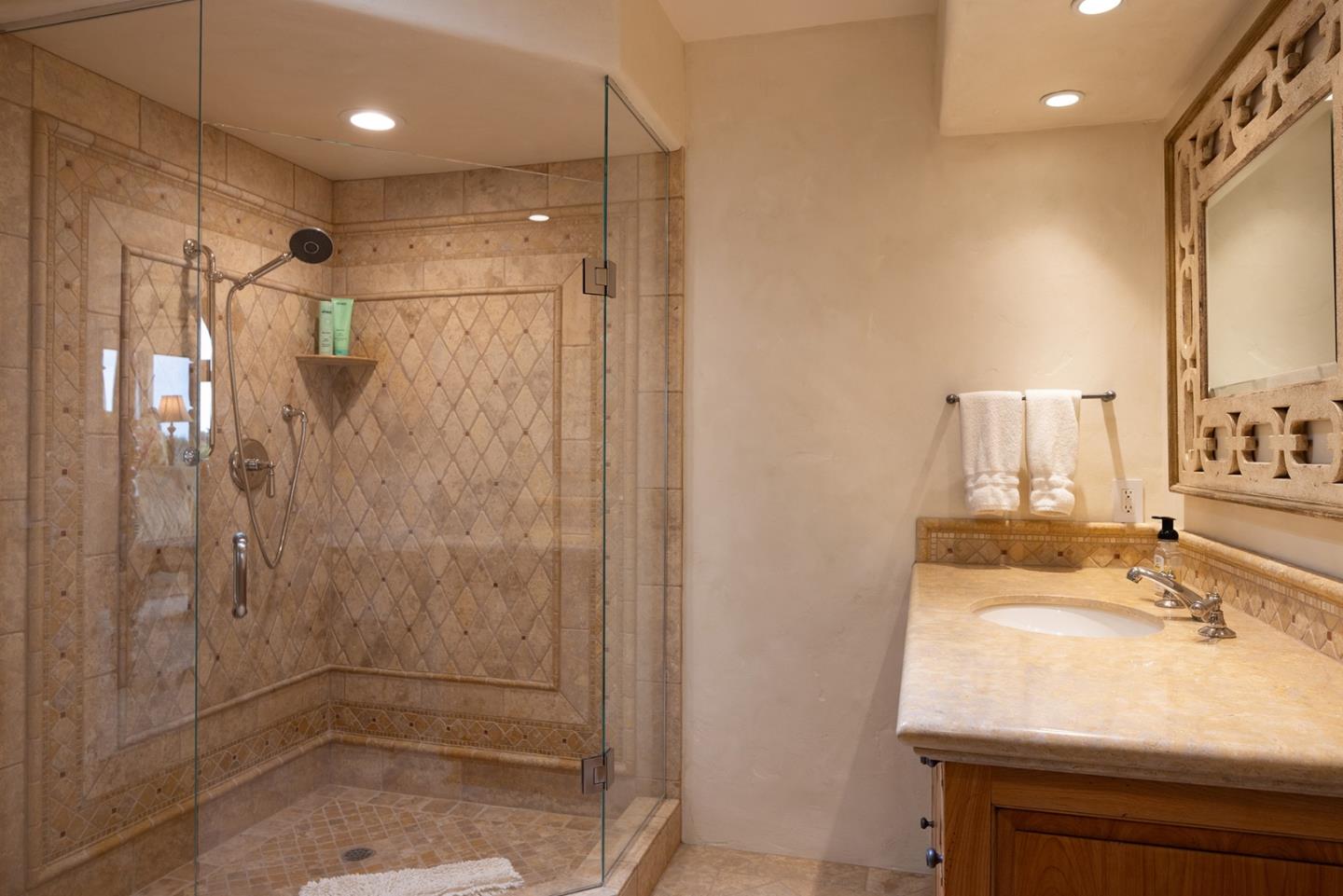 31453 Highway 1 Carmel, CA 93923 - Photo 50 of 58 a bathroom with a shower sink vanity and mirror