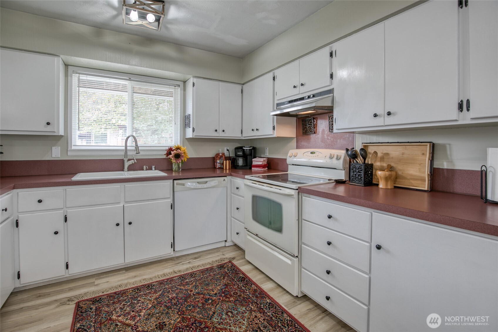 218 Holly Lane Cosmopolis, WA 98537 - Photo 12 of 30 a kitchen with cabinets appliances a sink and a window