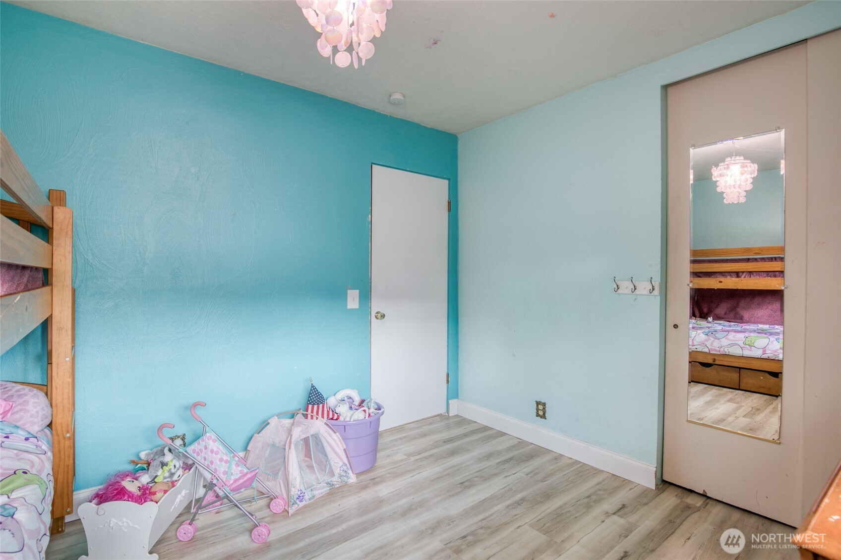 218 Holly Lane Cosmopolis, WA 98537 - Photo 19 of 30 a bedroom with a bed and a chandelier