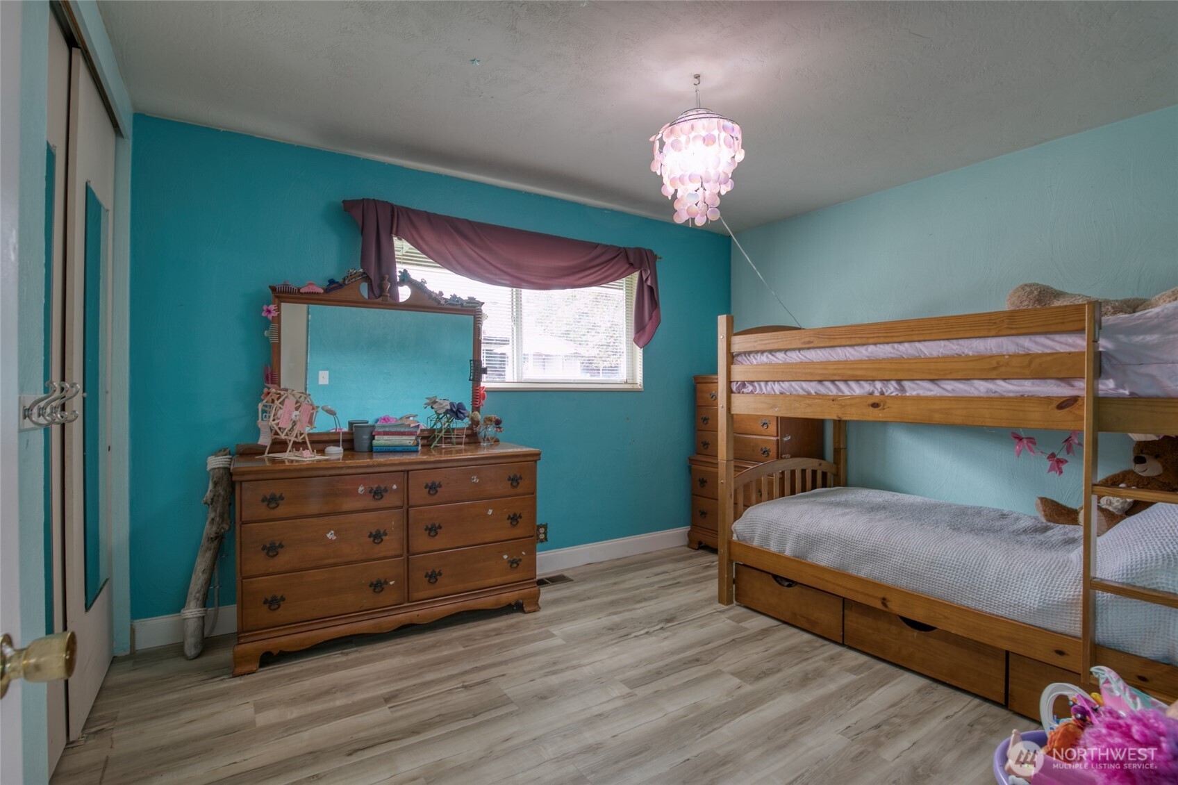 218 Holly Lane Cosmopolis, WA 98537 - Photo 20 of 30 a bedroom with a bed and a chandelier