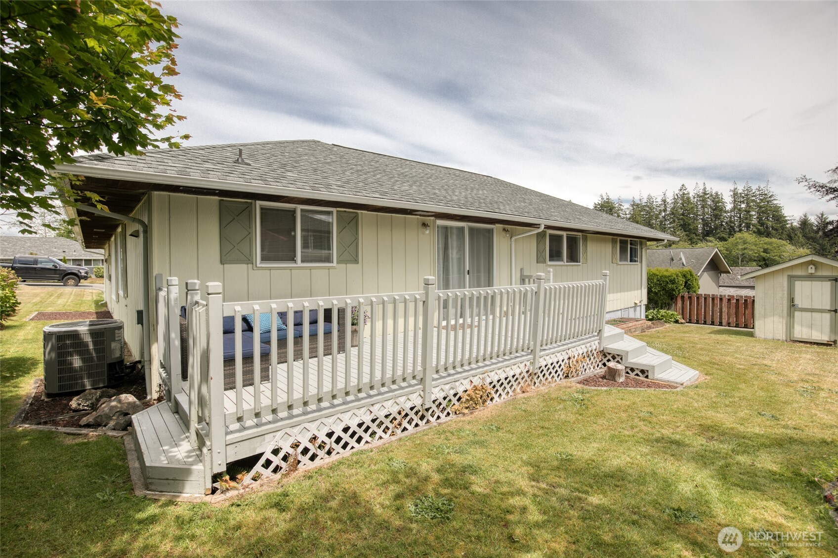 218 Holly Lane Cosmopolis, WA 98537 - Photo 4 of 30 a white house that has a small yard and wooden fence