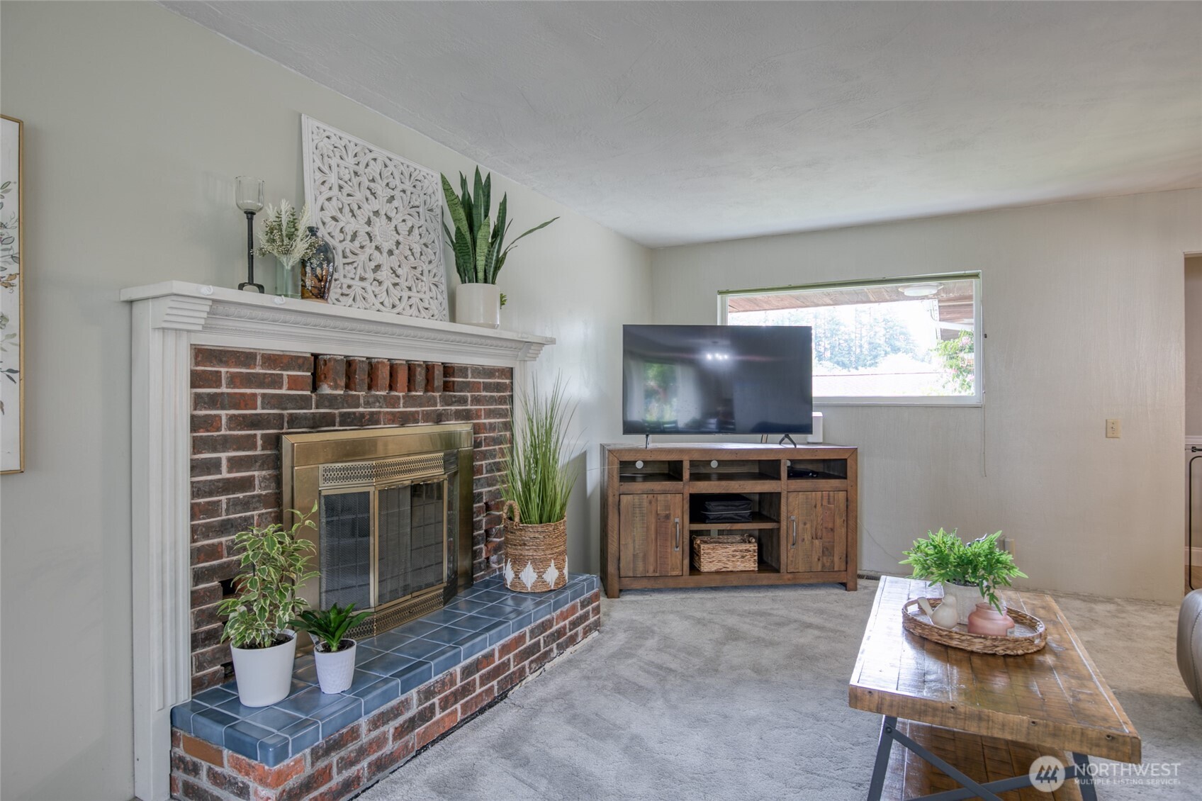 218 Holly Lane Cosmopolis, WA 98537 - Photo 6 of 30 a living room with furniture a flat screen tv and a fireplace