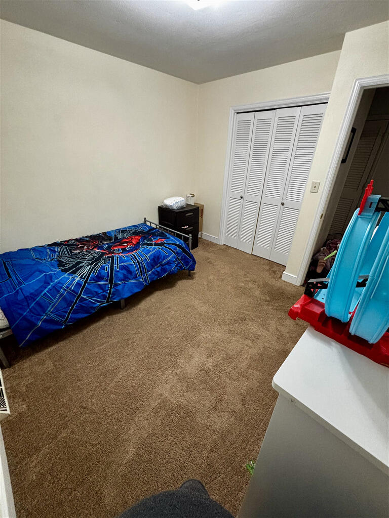 1032 Windy Ridge Drive Bedford, VA 24523 - Photo 16 of 27 a bedroom with a bed and a flat screen tv