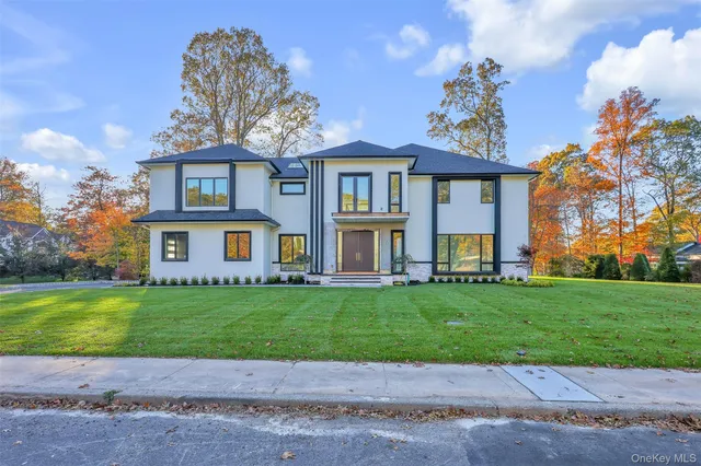 a front view of a house with a garden