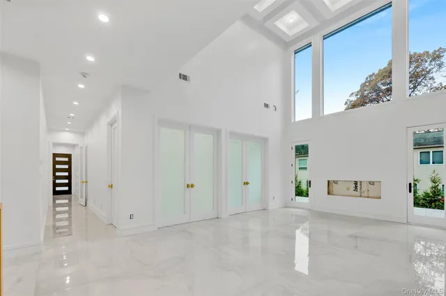 a view of a large kitchen with a tub and large windows