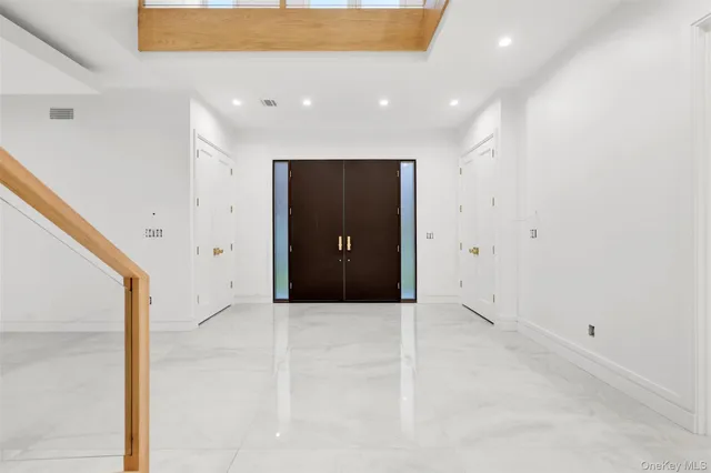 a view of entryway and hall with a front door
