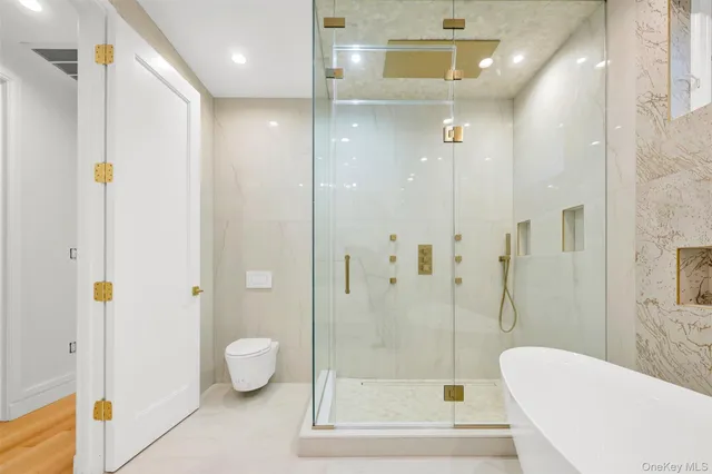 a bathroom with a shower a toilet and sink