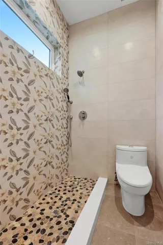 a bathroom with a toilet and a shower