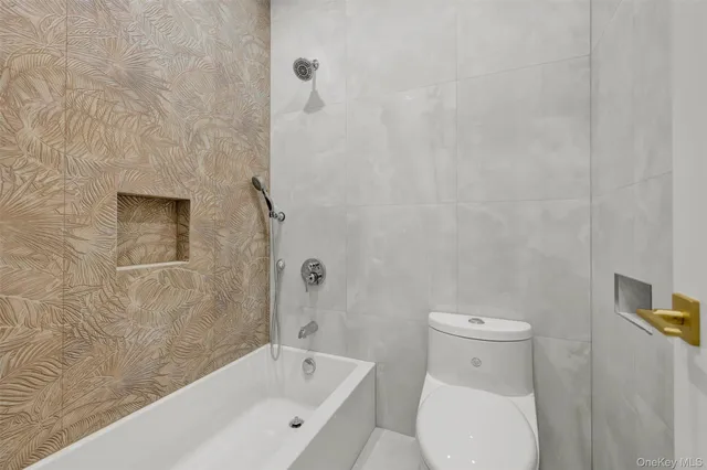 a bathroom with a toilet and bathtub