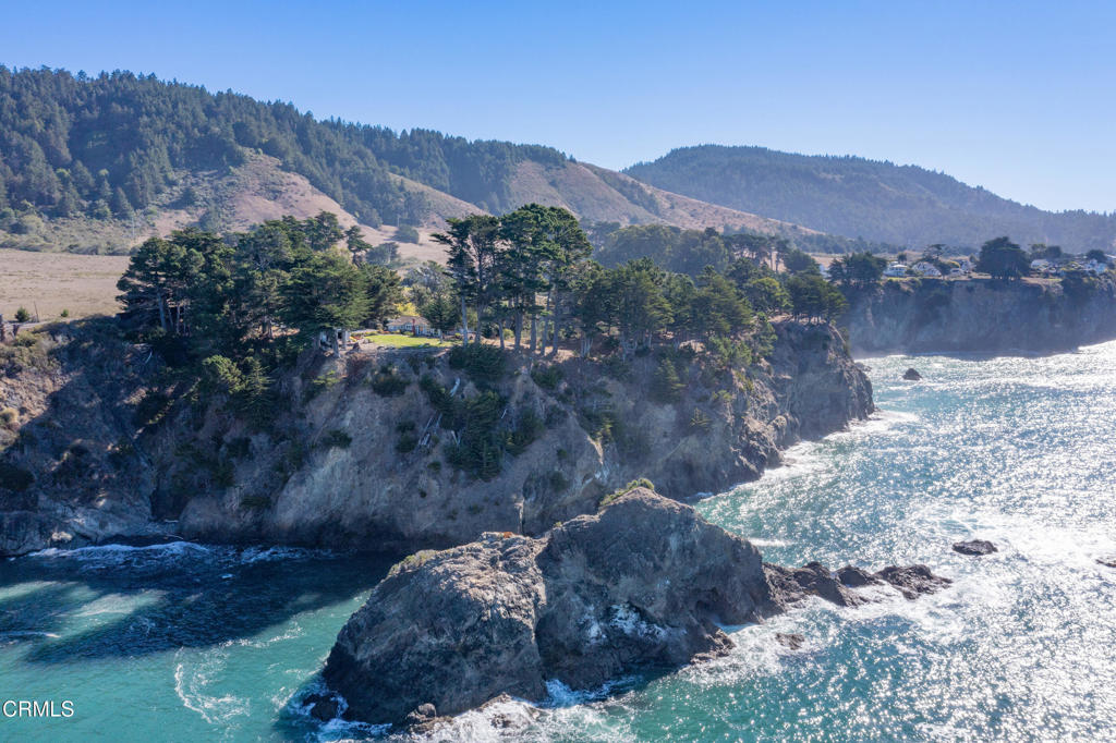 5420 Highway 1 Elk, CA 95432 - Photo 16 of 72 a view of a lush green hillside and a building