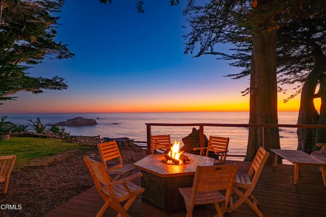 a view of outdoor space with sign board and wooden fence