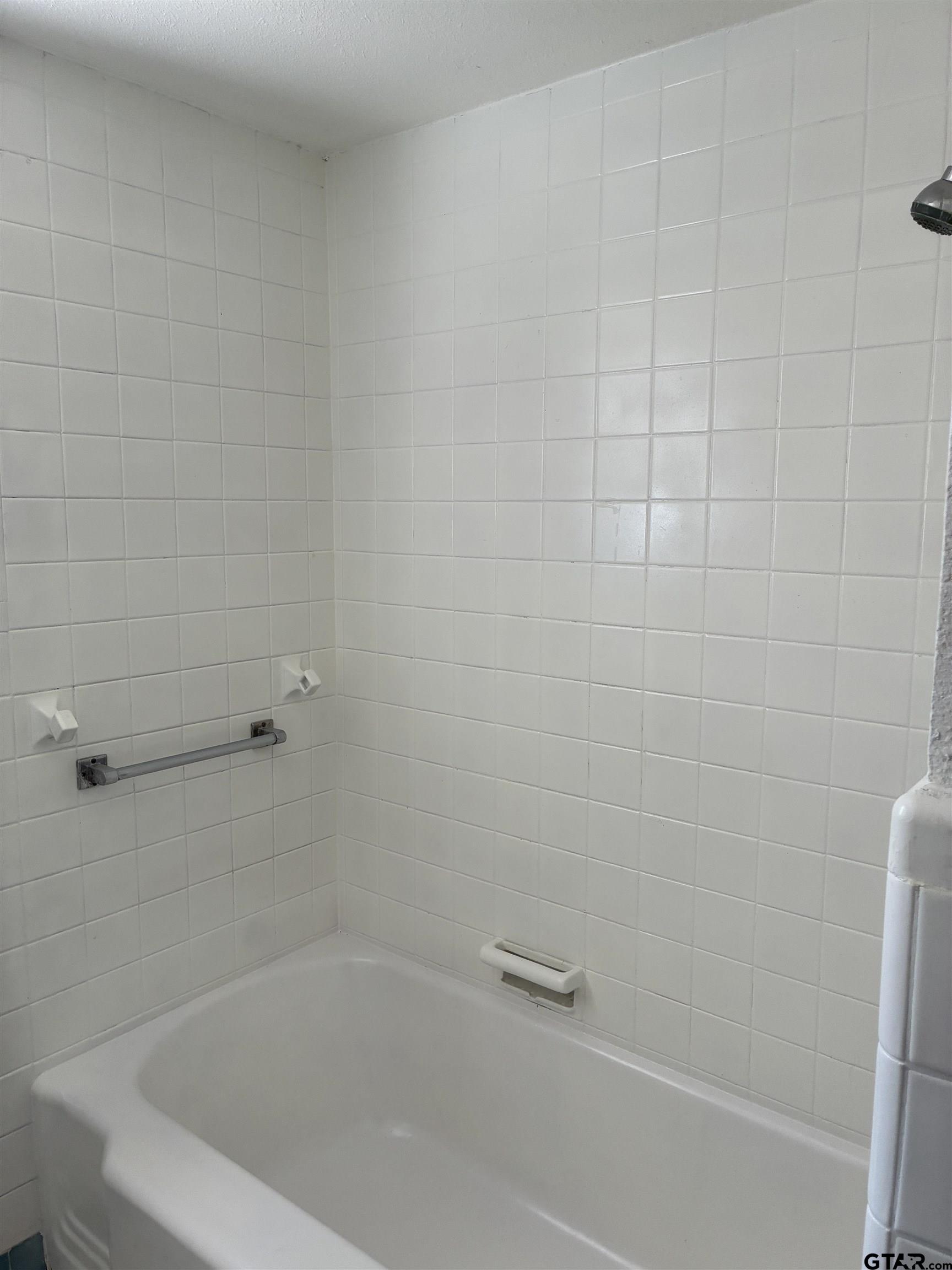 811 West 5th Street Tyler, TX 75701 - Photo 16 of 26 a close up of a bathtub curtain