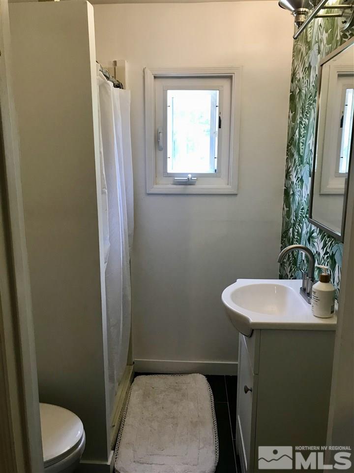 1033 University Terrace Reno, NV 89503 - Photo 15 of 22 a bathroom with a sink toilet and shower