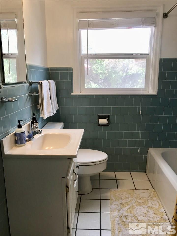 1033 University Terrace Reno, NV 89503 - Photo 17 of 22 a bathroom with a sink toilet and mirror