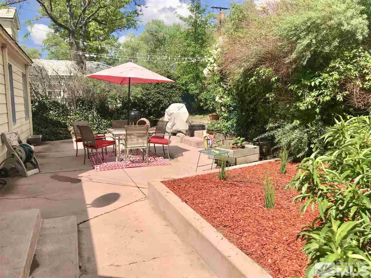 1033 University Terrace Reno, NV 89503 - Photo 20 of 22 a view of a backyard with chairs and a small yard