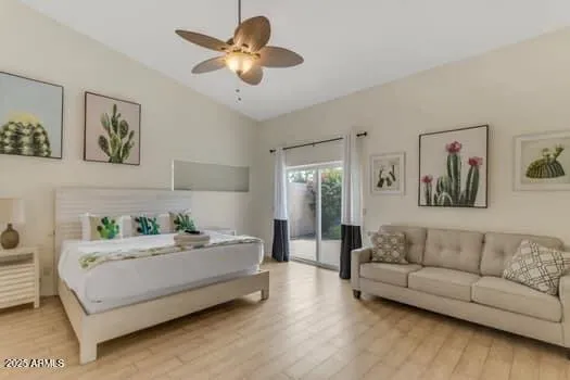 a bedroom with a large bed and wooden floor