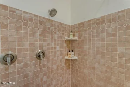a large white kitchen with a sink a large mirror and cabinets