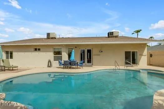 a view of a swimming pool with a patio