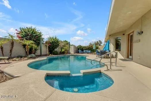 a view of a house with swimming pool and a yard
