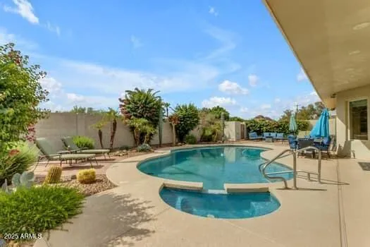 a view of a house with backyard and sitting area