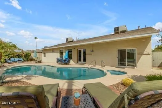 a living room with patio furniture and a flat screen tv