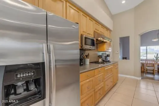 a kitchen with stainless steel appliances granite countertop a refrigerator and a stove